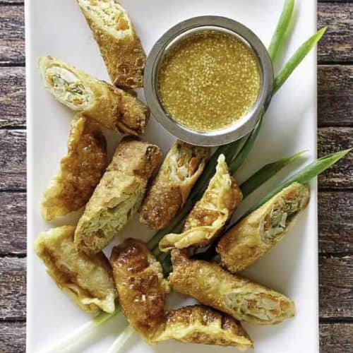 homemade Benihana magic mustard sauce and egg rolls on a platter