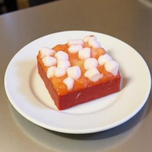 A layered jello salad with fruit cocktail and marshmallows.