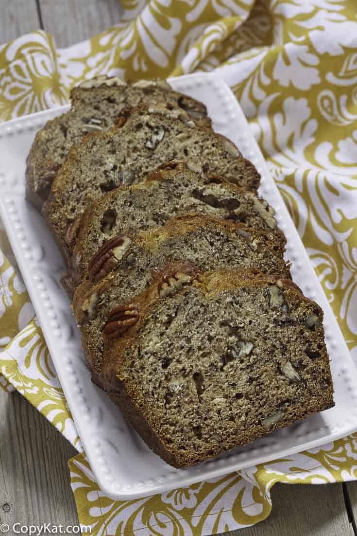4 slices of banana bread with pecans on a plate