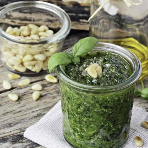 a jar of homemade pesto with pine nuts