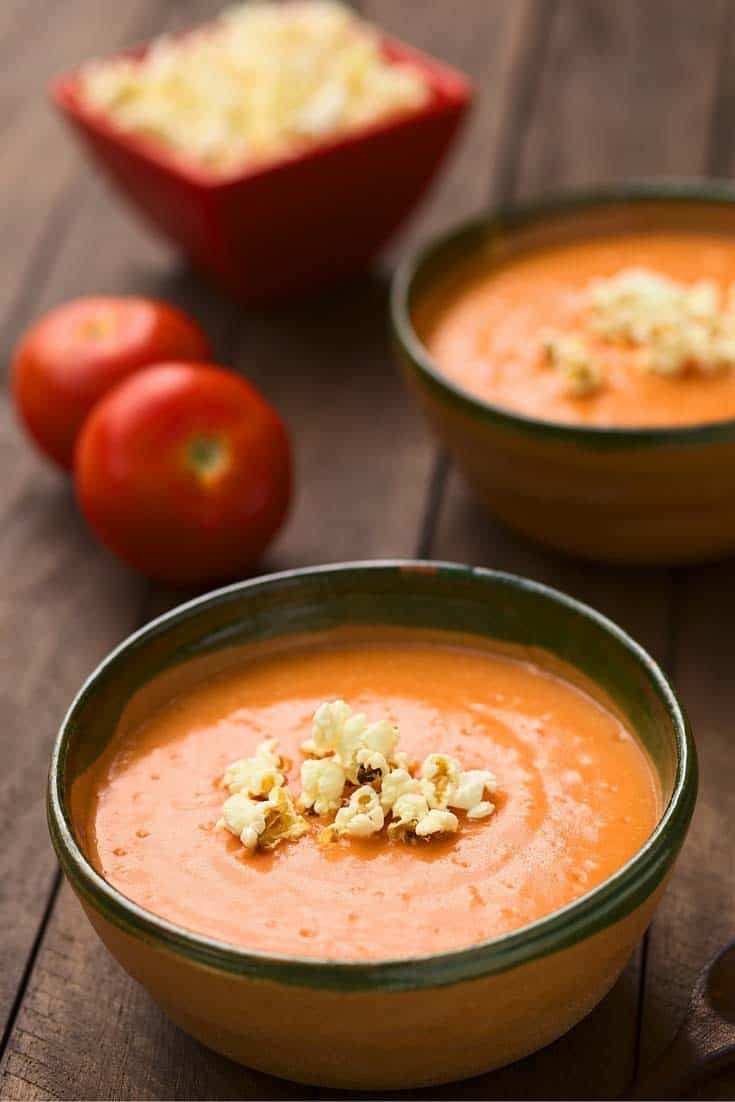 two bowls of creamy tomato soup