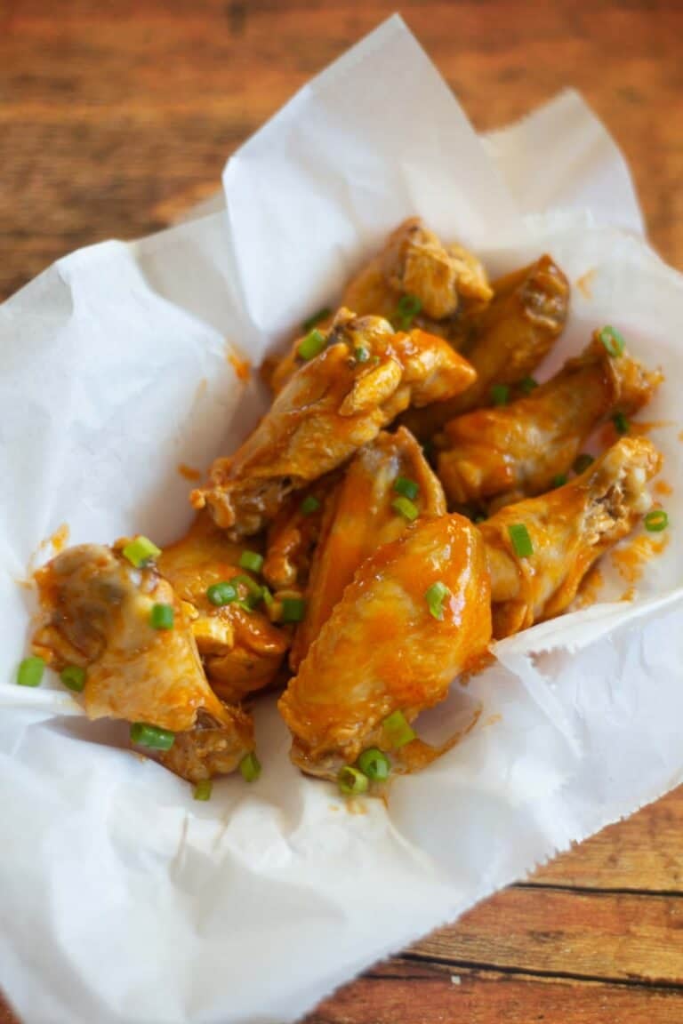 A basket of air fryer garlic buffalo chicken wings.