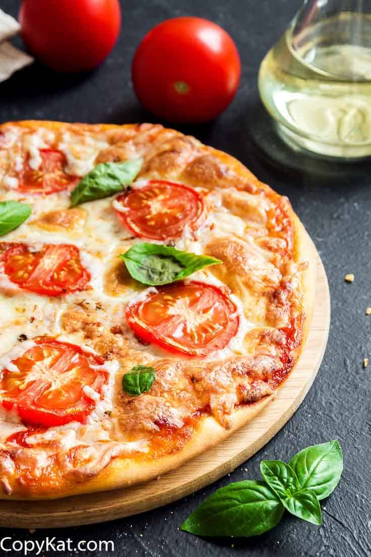 Margherita pizza on a pizza stone.