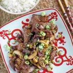 A plate of Mongolian beef and a bowl of rice