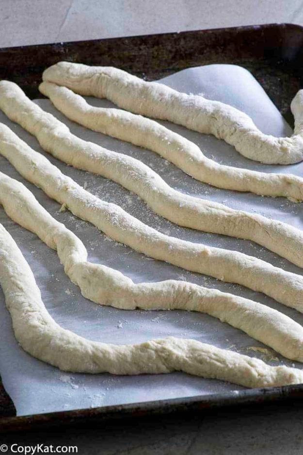 Rolling out dough to make Auntie Anne's homemade pretzels.