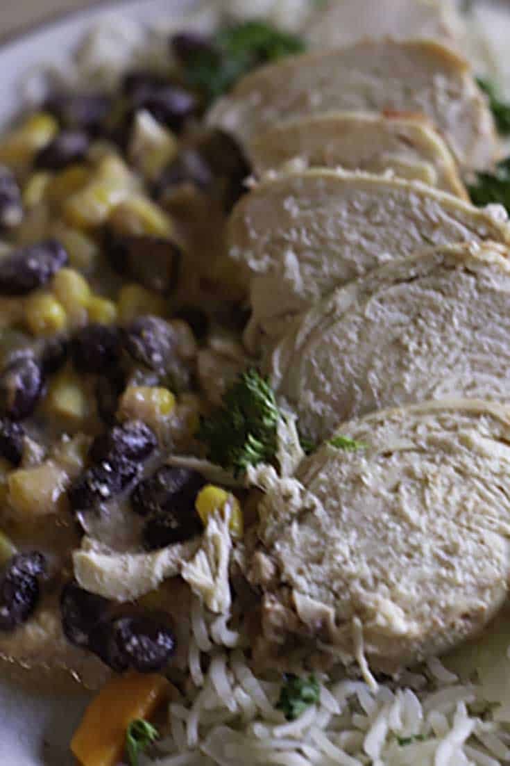 A plate of black beans, corn, and chicken that were prepared in a slow cooker.
