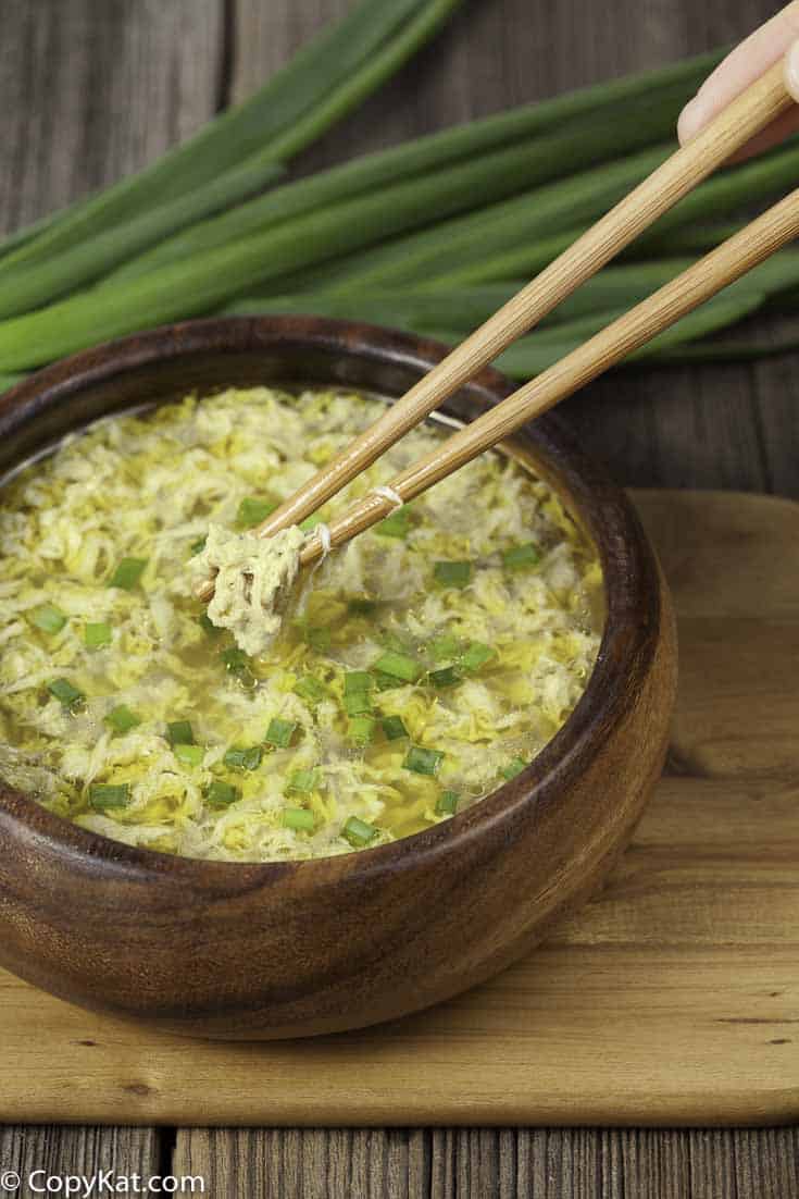A bowl of egg drop soup with green onions.