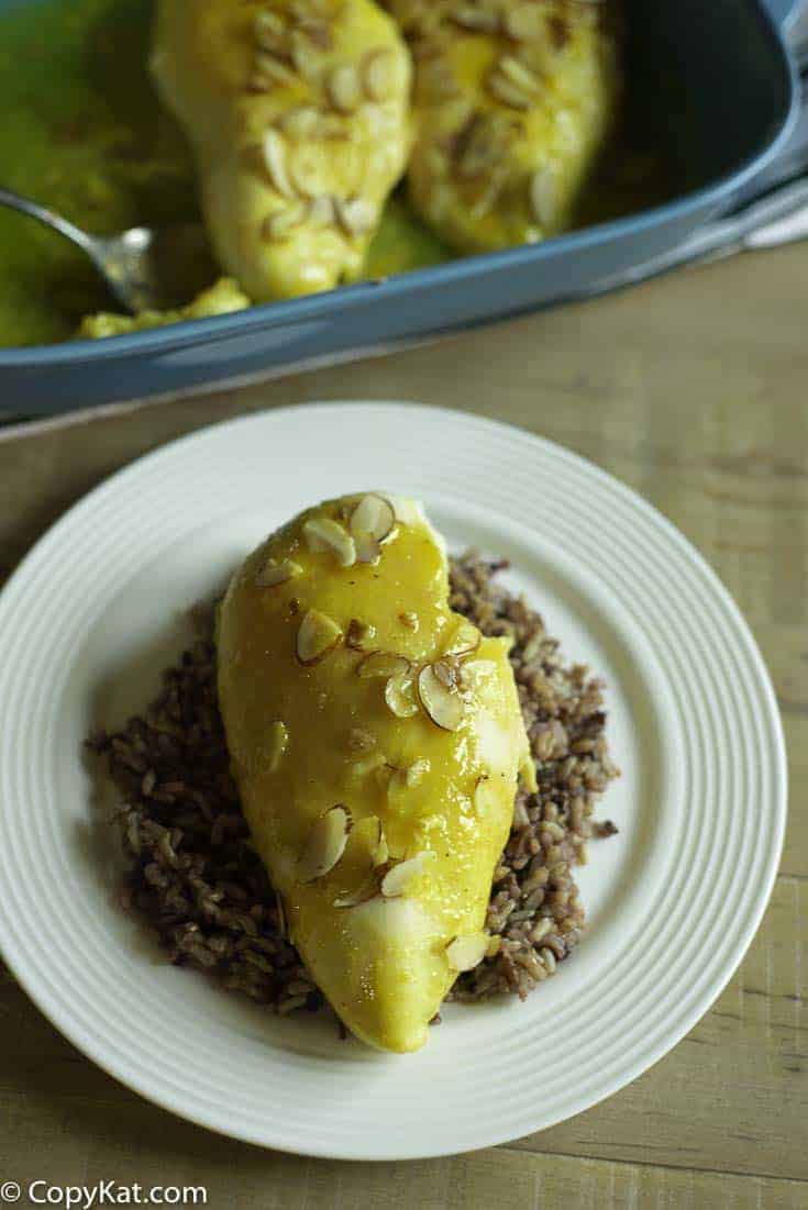 A plate with a chicken breast made with a sauce of lemon Jello and more.