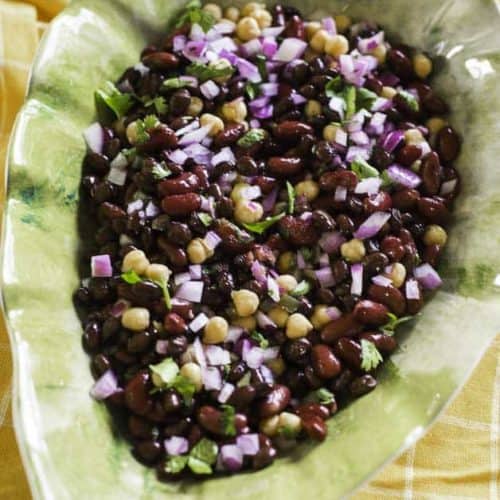 mexican three bean salad with red onions, cilantro in a bowl