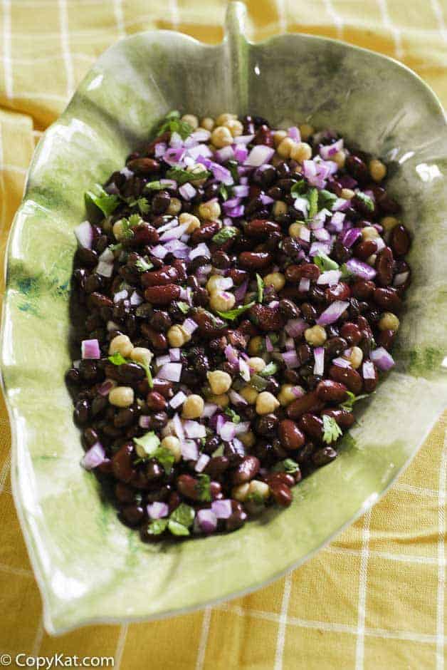 mexican three bean salad with red onions, cilantro in a bowl