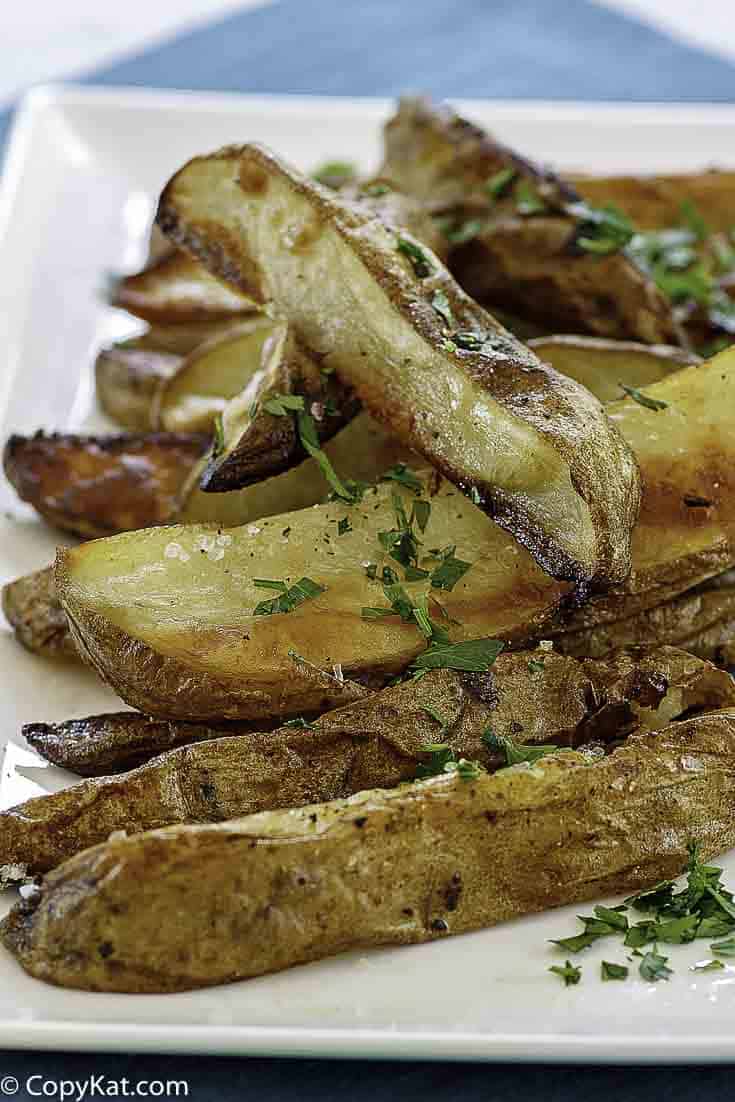 a plate of roasted potatoes with herbs