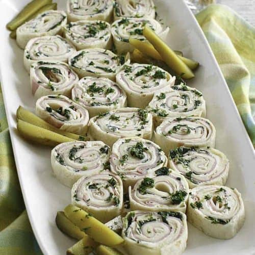 ham and cheese tortilla pinwheel roll ups on a platter