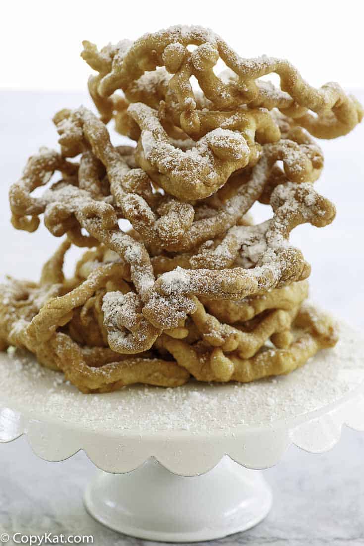 Homemade funnel cakes dusted with powder sugar.