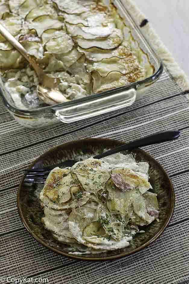 a plate of cheesy scalloped potatoes and ham