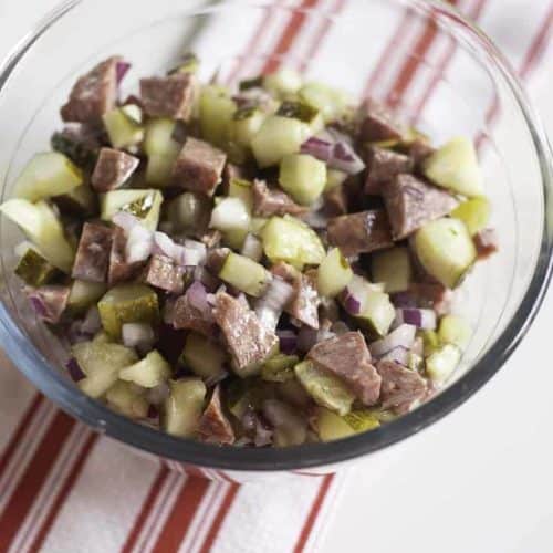 salami salad made with salami, onions, pickles, and olive oil