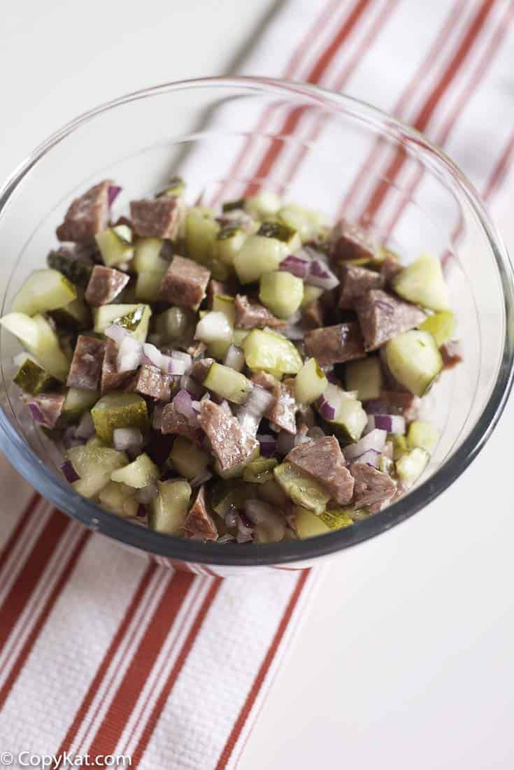 salami salad made with salami, onions, pickles, and olive oil
