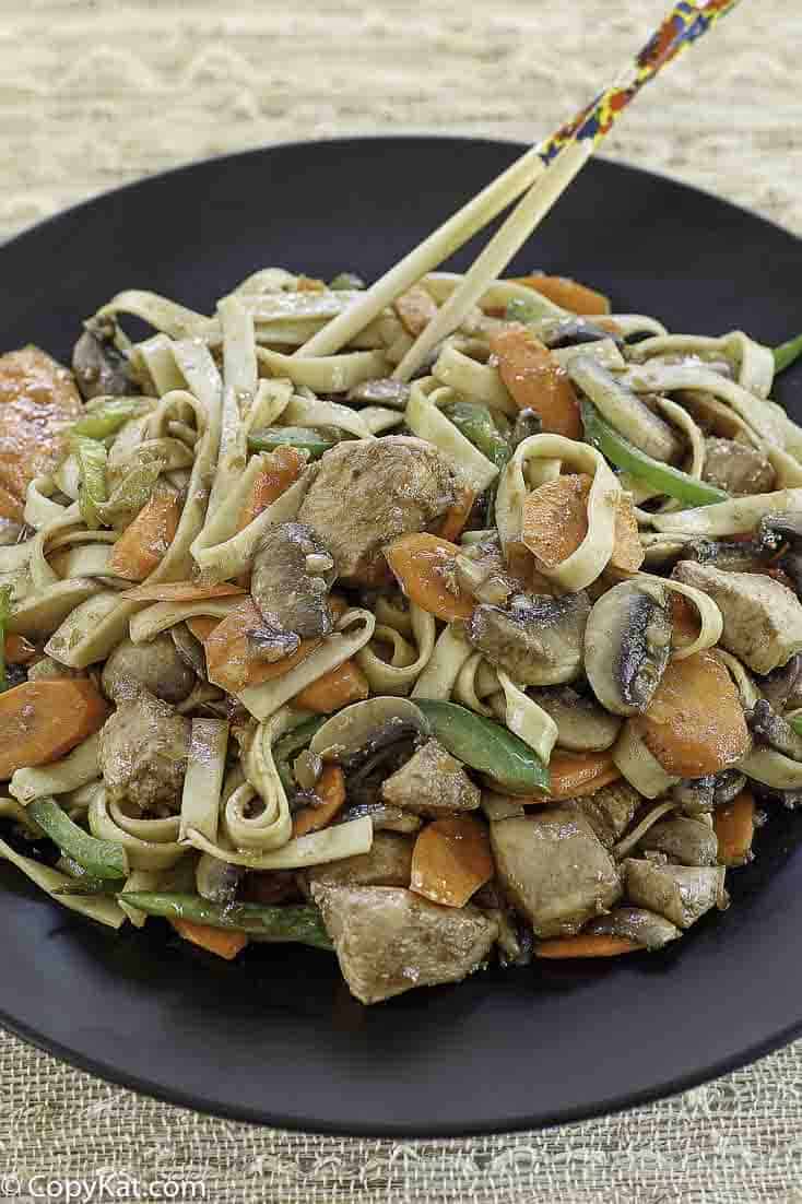 a plate of chicken lo mein made at home