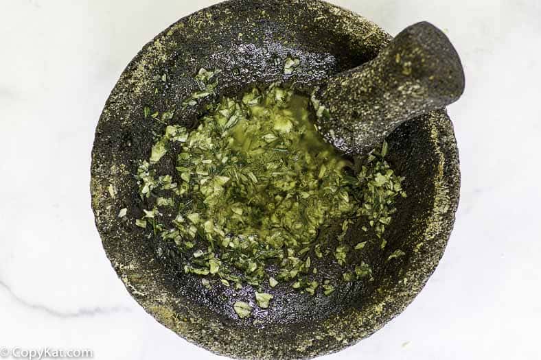 combining rosemary, garlic, salt, and olive oil