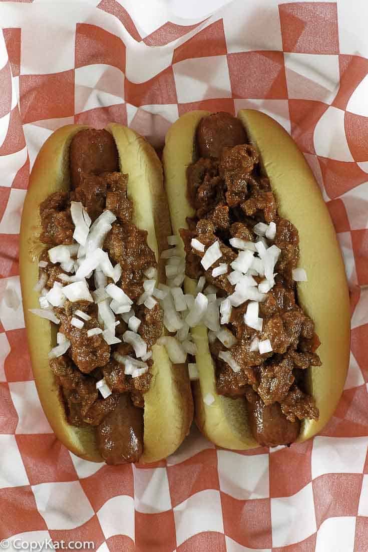 chili con carne on top of hot dogs