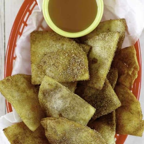 a basket of cinnamon sugar tortilla chips and honey