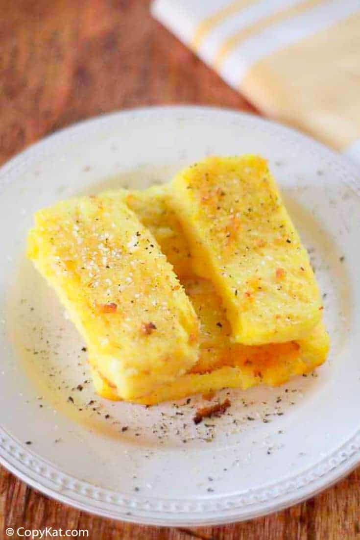 fried cornmeal mush on a white plate