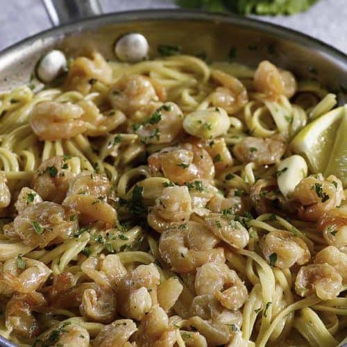 a skillet of garlic shrimp pasta