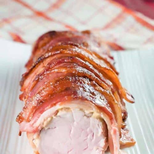 brown sugar bacon wrapped pork tenderloin on a platter