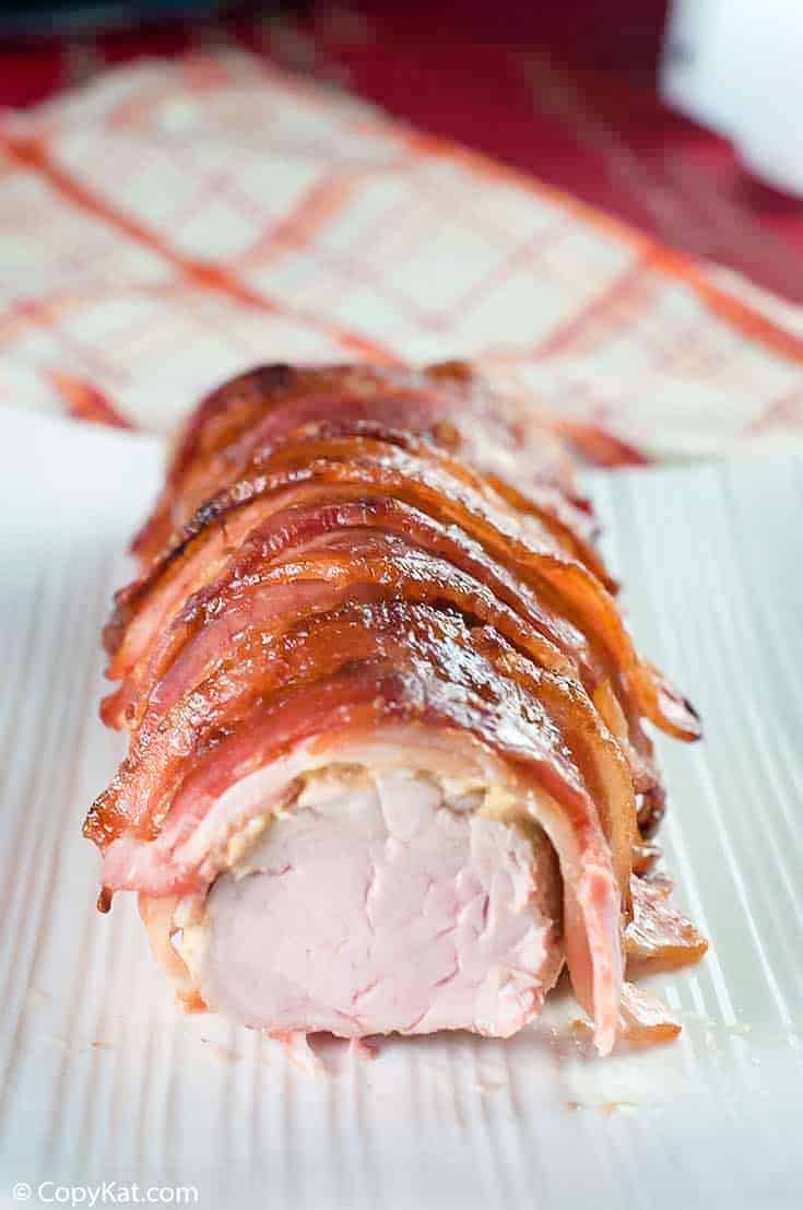 brown sugar bacon wrapped pork tenderloin on a platter