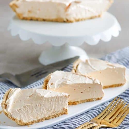 three slices of kool aid pie with the remaining pie on a stand