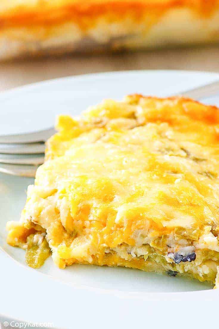 a slice of chili relleno casserole and a fork on a plate
