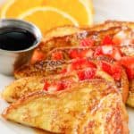 French toast with syrup and chopped strawberries