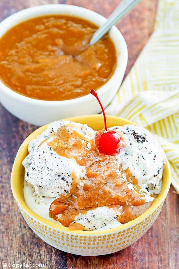 a bowl of cookies and cream ice cream with peanut butter sauce on top