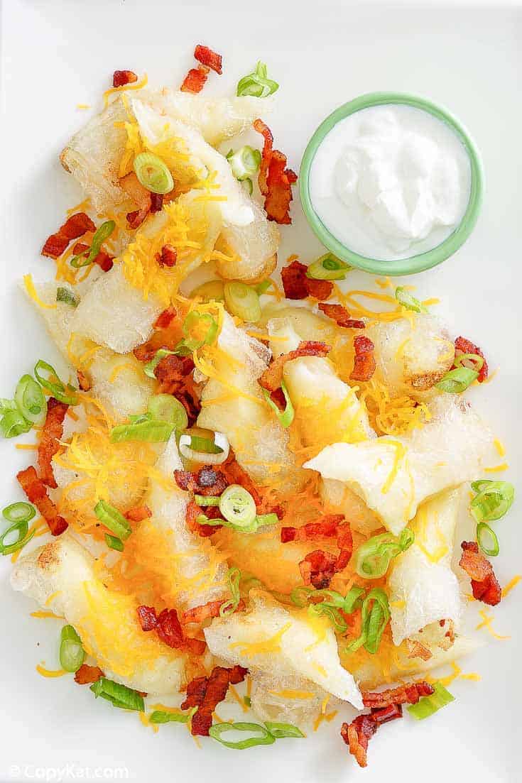 mashed potato spring rolls topped with bacon and cheese