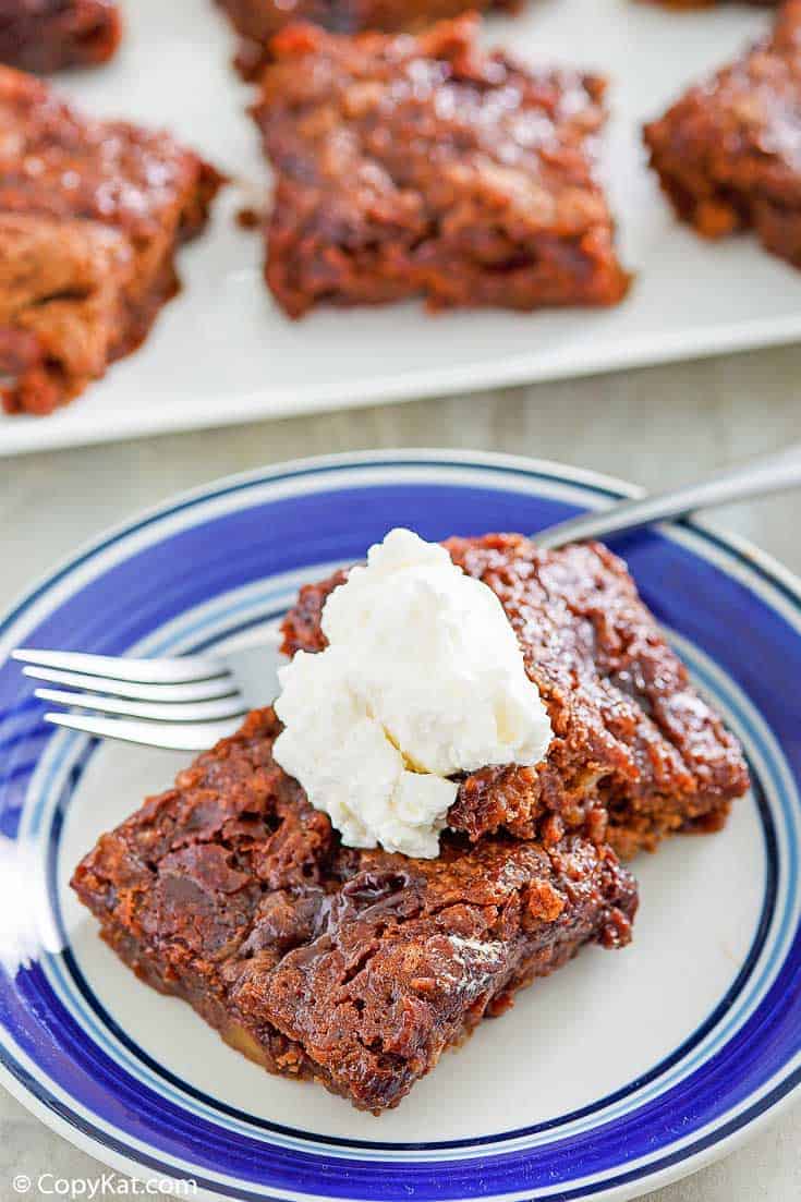 two slices of chocolate pudding cake topped with whipped cream