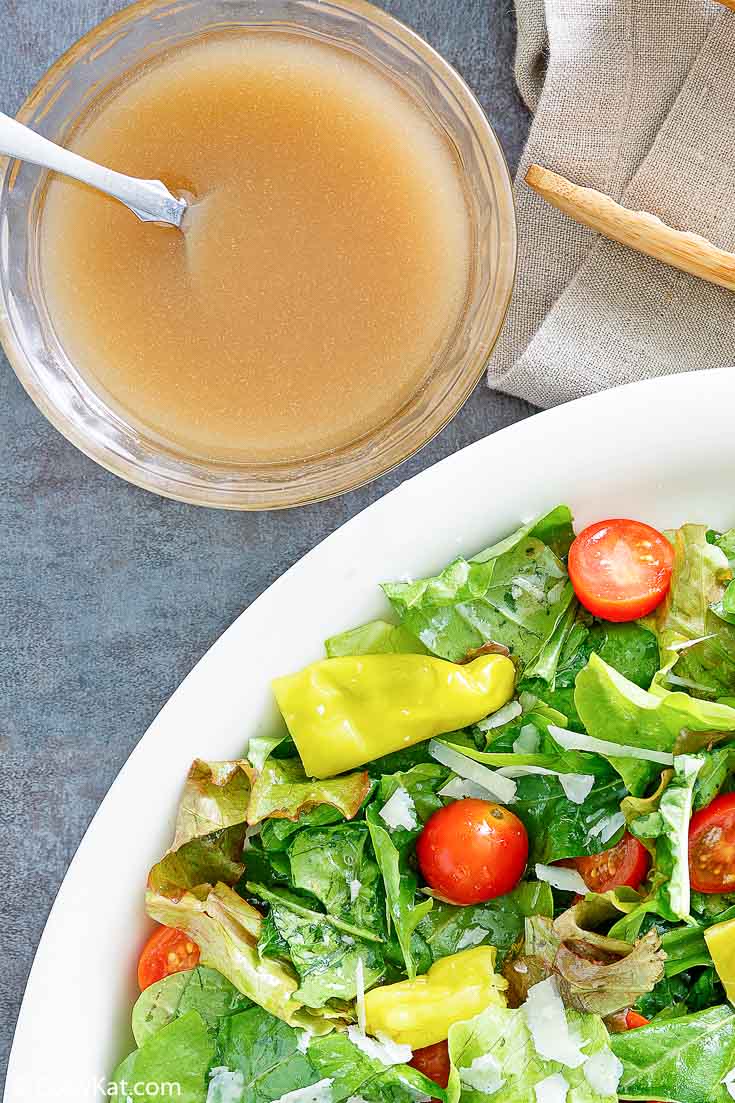 homemade Luigetta's salad dressing next to a salad
