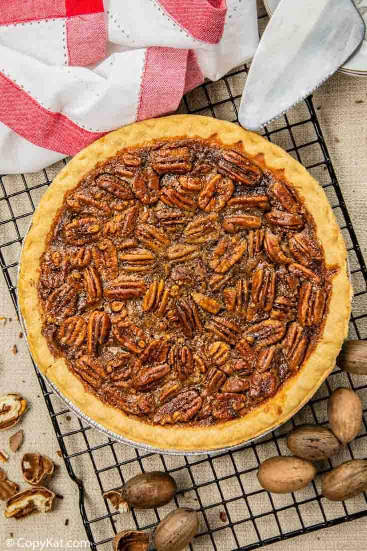 a whole pecan pie on a wire cooling rack