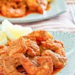 Homemade Red Lobster Cajun Shrimp and lemon wedges on a blue plate
