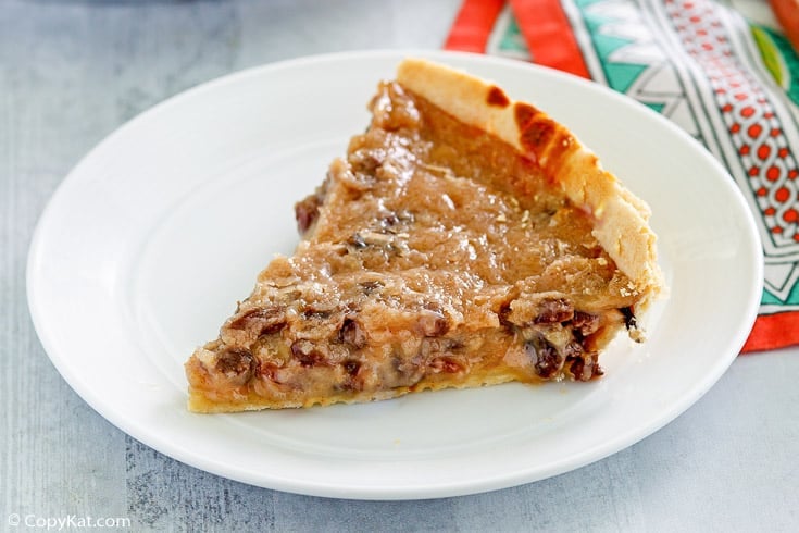 a slice of sour cream raisin pie on a white plate