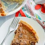 a slice of sour cream raisin pie and a fork on a plate