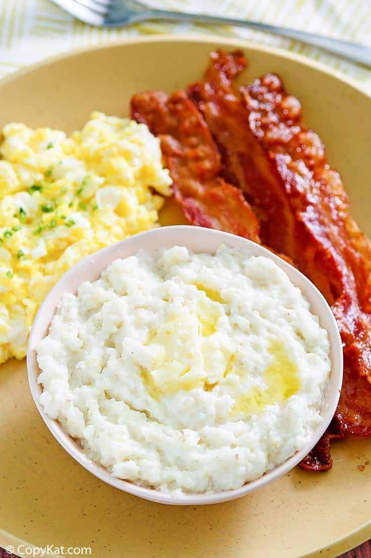 bacon, eggs, and grits on a plate