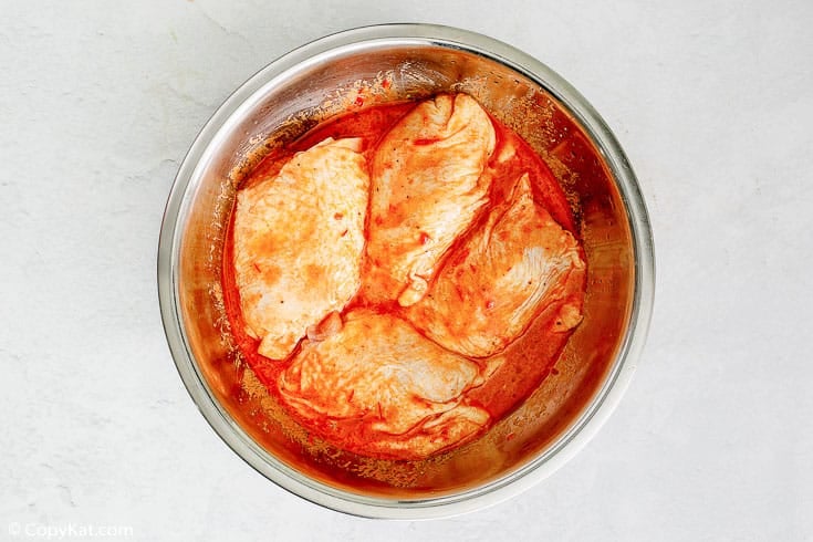 chicken thighs and Peruvian marinade in a bowl