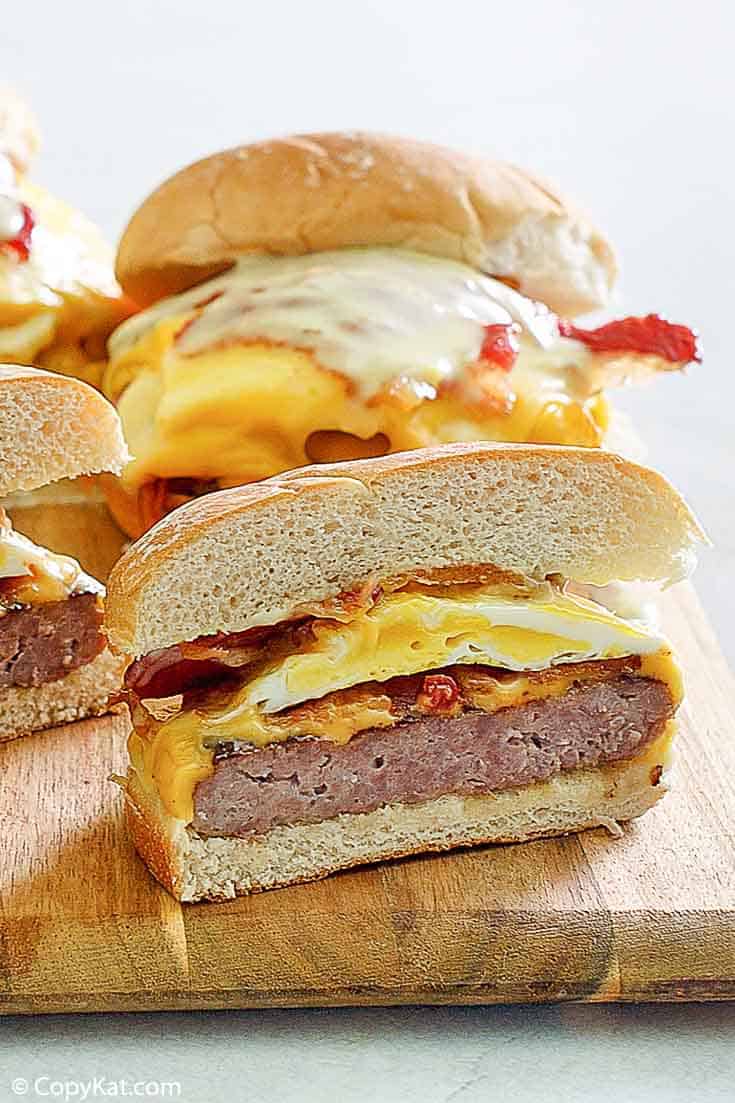homemade Wendys Breakfast Baconator Sandwiches on a wood board