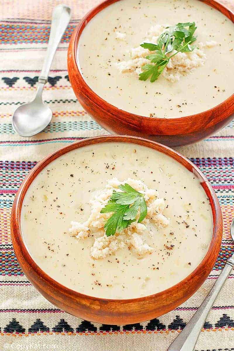two bowls of crab bisque and two spoons
