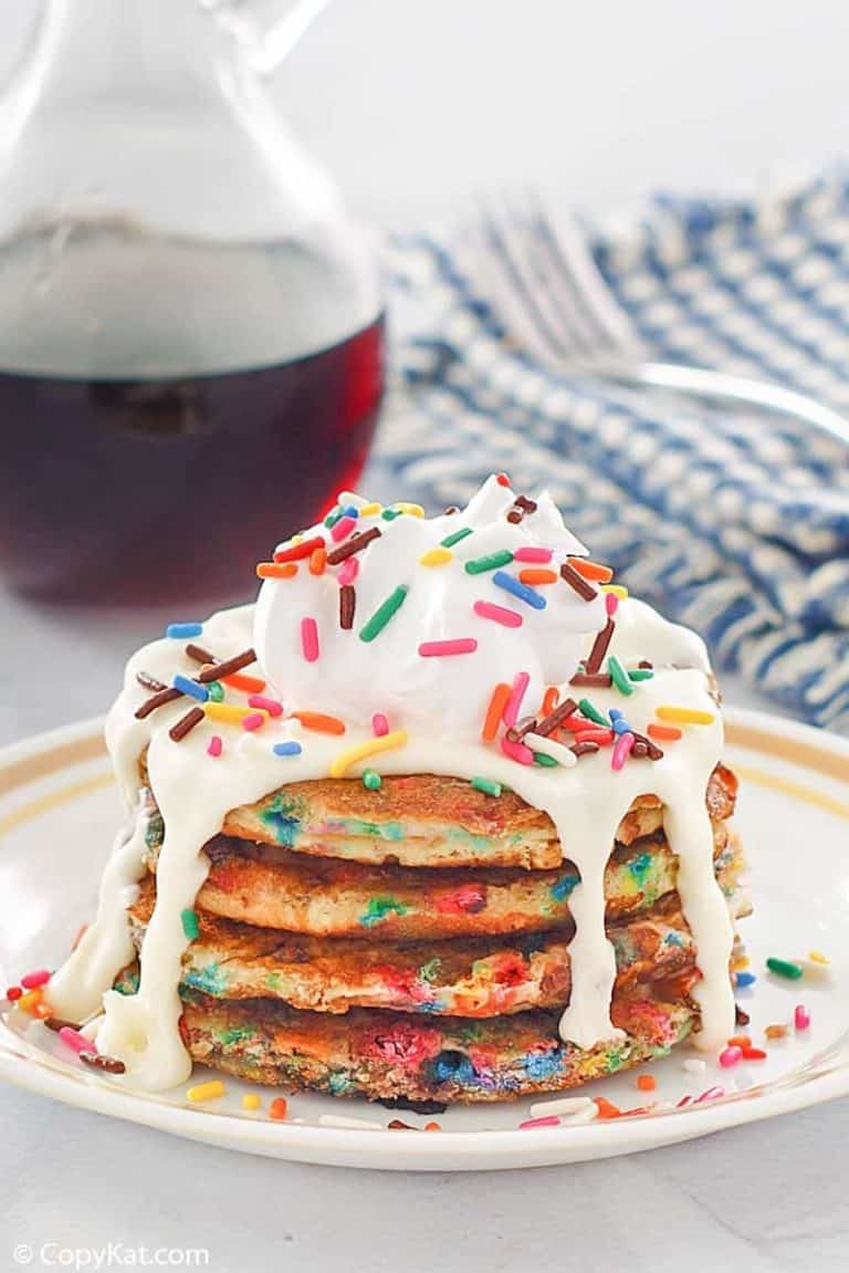 a stack of homemade IHOP cupcake pancakes with icing and syrup