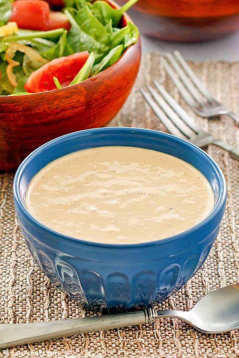 a bowl of homemade Russian dressing and a salad