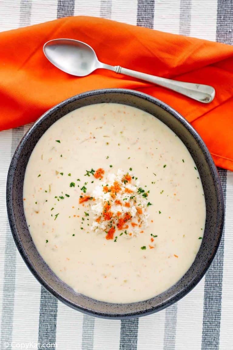overhead view of a bowl of she crab soup, a napkin, and spoon