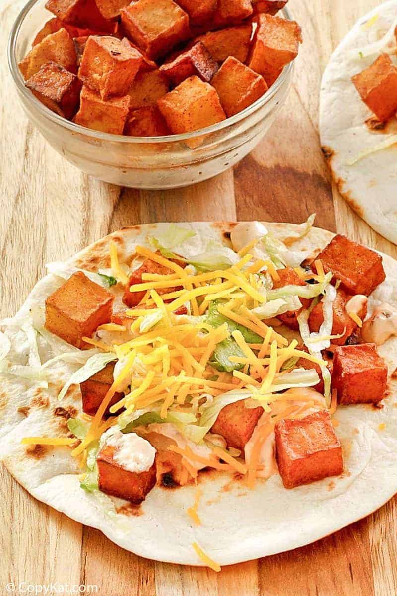 spicy potato taco with chipotle sauce, lettuce, and cheese