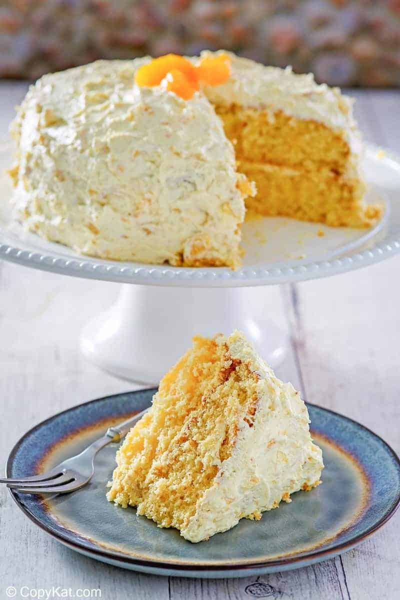 Ambrosia Cake on a cake stand and a slice on a plate