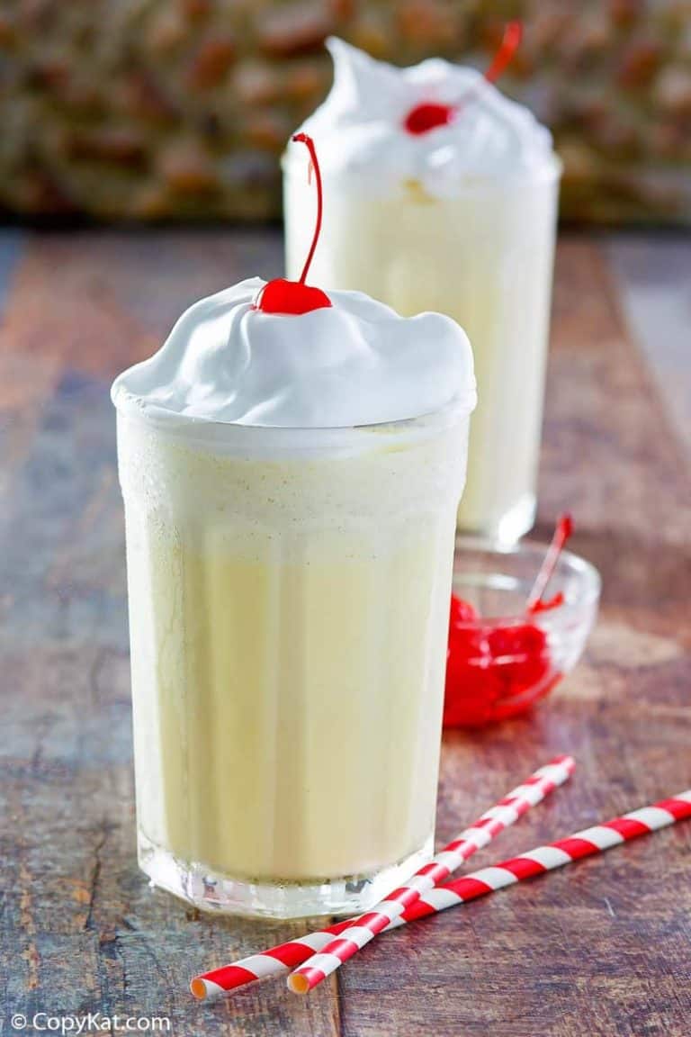 Homemade McDonald's eggnog shake with whipped cream and a cherry on top