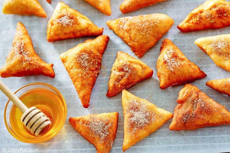 cinnamon sugar sopapillas and a bowl of honey